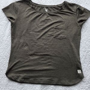 Vuori performance pocket tee in a dark heather green or olive Oversized